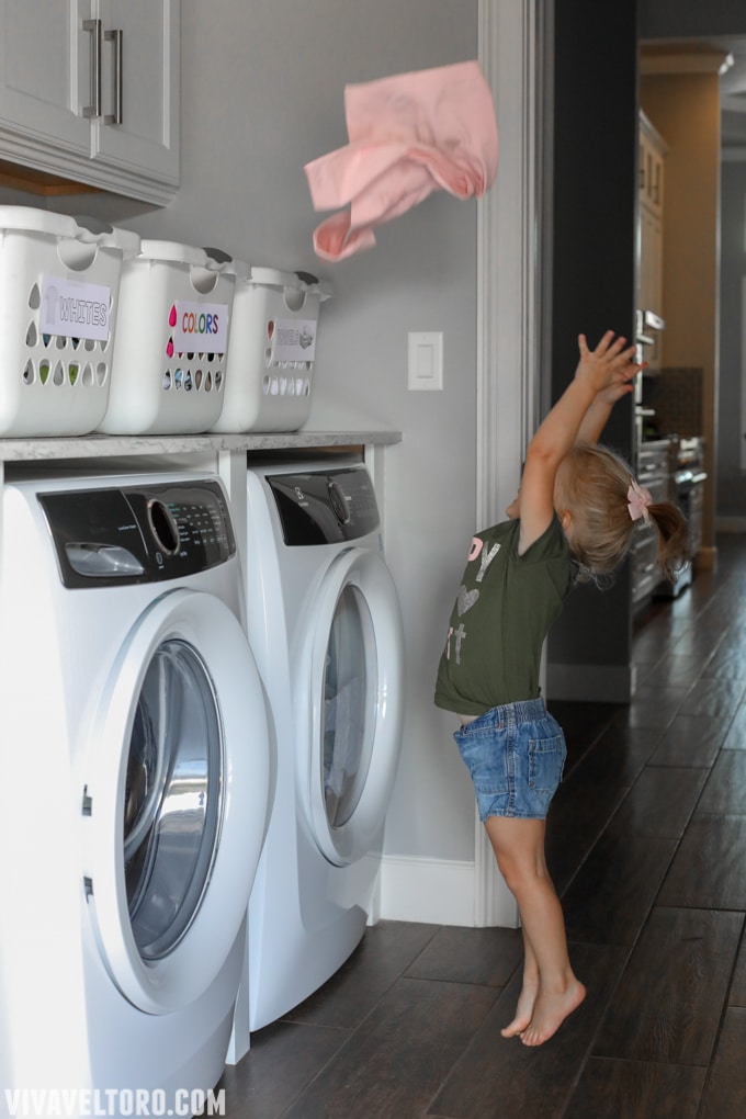 child sorting laundry