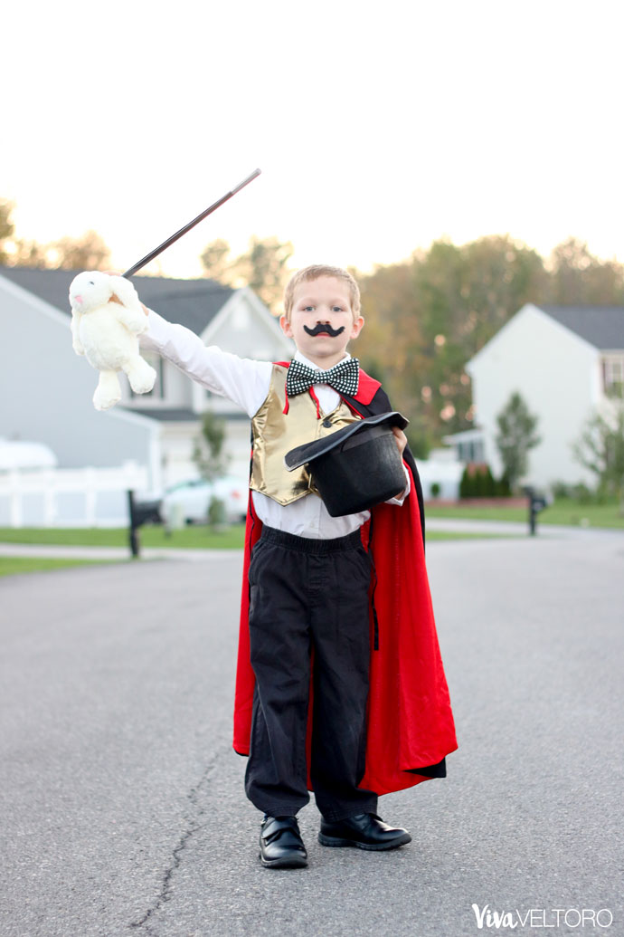 kids magician costume and pulling a rabbit out of a hat